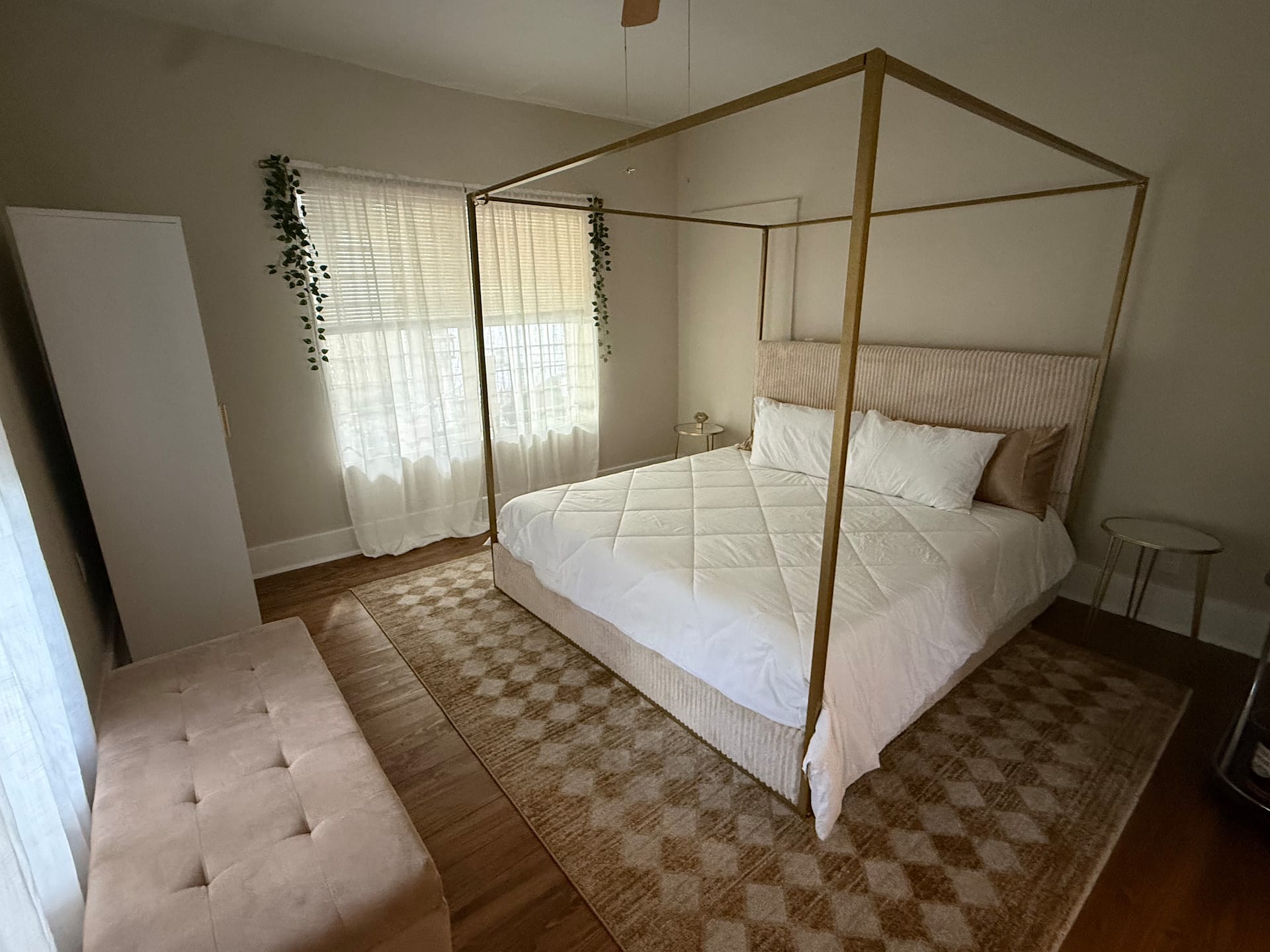 A light-filled bedroom with a canopy bed at the Hideaway